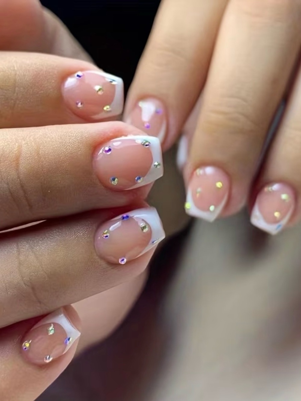 Classic White French Tip Nail Art with Iridescent Rhinestones
